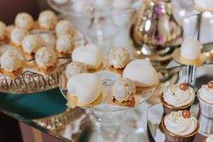 Candy bar at a wedding. Delicious desserts. Beautiful decorations. Fruits. Sweet cakes on your holiday. Birthday. Sweet life. photo