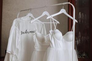 Bedroom interior with wedding dress prepared for the ceremony. A beautiful lush wedding dress on a mannequin in a hotel room. photo