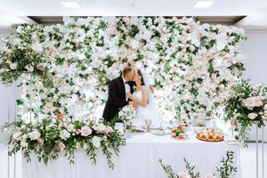 Stolen moments at their wedding. The groom kisses the bride during the wedding celebration. photo