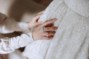 close-up of female hands touching dress. Women's manicure. A luxurious wedding ring on a woman's finger. photo