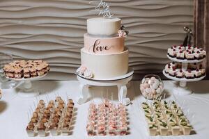 Candy bar at a wedding. Delicious desserts. Beautiful decorations. Fruits. Sweet cakes on your holiday. Birthday. Sweet life. photo