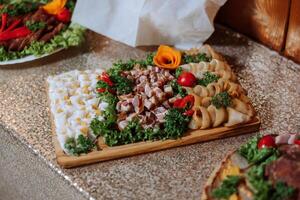 Meat and cheese snacks on the buffet. A buffet in a closed room, at a wedding celebration or birthday. Sandwiches on skewers before the start of the holiday. photo