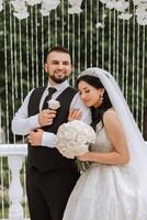 el novia y novio abarcar. el novia suavemente abrazos el novio por el espalda. hermosa Boda Pareja. el concepto de romance en un recién casados relación. Luna de miel. foto