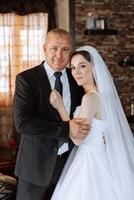 A beautiful bride with her father on her wedding day. The best moments of the wedding day. Daughter and father. photo