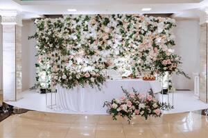 Restaurant wedding table for bride and groom. luxury wedding table with beautiful flowers. pink stylized photo