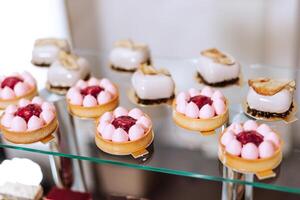 Candy bar at a wedding. Delicious desserts. Beautiful decorations. Fruits. Sweet cakes on your holiday. Birthday. Sweet life. photo