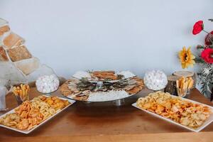 Meat and cheese snacks on the buffet. A buffet in a closed room, at a wedding celebration or birthday. Sandwiches on skewers before the start of the holiday. photo