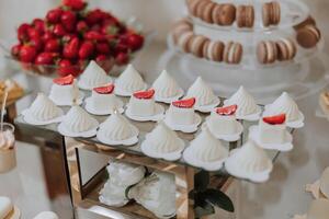 Candy bar at a wedding. Delicious desserts. Beautiful decorations. Fruits. Sweet cakes on your holiday. Birthday. Sweet life. photo