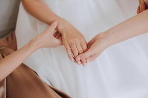 tender hands of a young woman with an expensive ring and a beautiful manicure. Close-up photo of female hands