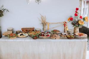 Meat and cheese snacks on the buffet. A buffet in a closed room, at a wedding celebration or birthday. Sandwiches on skewers before the start of the holiday. photo