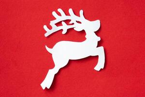 Christmas reindeer cut out paper on red background photo