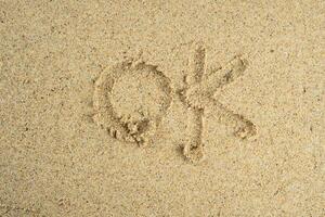 sand with ok text photo