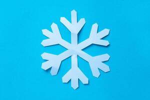 snowflake cut out paper on blue photo