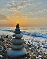 pyramid of stones on sea coast photo