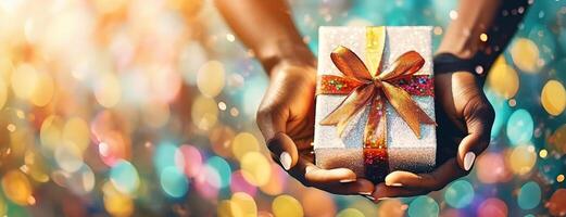 AI Generated Hands presenting a glittering gift box with a golden bow against a bokeh background. Panorama with copy space. photo