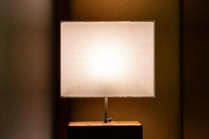 Luminous modern bedsides lamp at night. photo