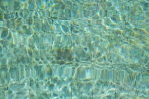 Water in swimming pool reflecting sunshine. photo