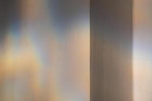 Reflected colourful light patterns on the wall. photo