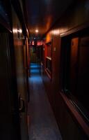 Empty vintage corridor of railway sleeping car at dusk. photo