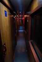 Empty hallway in old sleeping wagon of train at night. photo