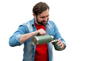 Young man sipping a mate, he is dressed casually and very happy. On an isolated white background. photo