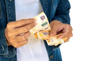 Argentine woman counting Argentine peso bills. photo