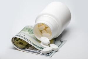 Concept of the cost of medicine, represented with a bottle of pills on a hundred dollar bill. photo