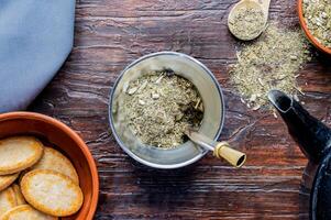 Composition of mate, yerba mate, kettle and cookies. Traditional Argentine breakfast and snack. photo