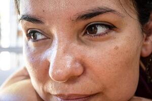 Eyes of a woman with newly made permanent eyelid liner. photo