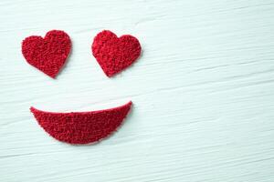 Smiley face with heart eyes made with pieces of plush. photo