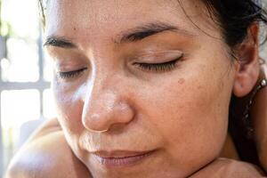 Very close photo of a Latin girl with permanent eyelid eyeliner.