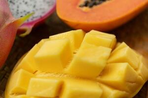 Delicious Exotic Tropic Fruits Top View on Wicker Mat Background photo