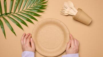 Paper plates and cups on a beige background photo