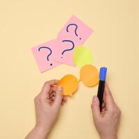 Paper stickers with question marks on a yellow background photo