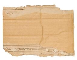 Piece of brown cardboard with torn edges on isolated background photo