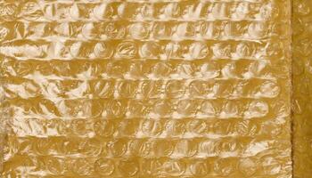 Texture of yellow paper with film and air bubbles, packaging material for transportation. photo