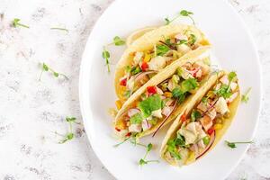 Mexican tacos with chicken meat, corn and salsa. Healthy tacos. Diet menu. Mexican taco. Top view, flat lay photo