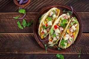 Mexican tacos with chicken meat, corn and salsa. Healthy tacos. Diet menu. Mexican taco. Top view, flat lay photo