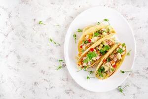 Mexican tacos with chicken meat, corn and salsa. Healthy tacos. Diet menu. Mexican taco. Top view, flat lay photo