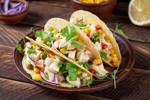 Mexican tacos with chicken meat, corn and salsa. Healthy tacos. Diet menu. Mexican taco. photo