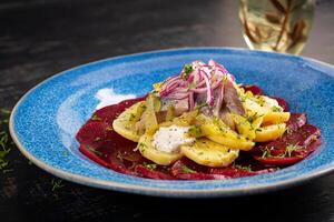 Spicy salad of herring, beets, potatoes, pickles and red onions. Healthy eating. photo