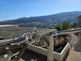 close up view of an eye bolt turnbuckle used for shade tie down to support structure photo