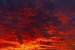 Dramatic sunset or sunrise view with orange and red clouds photo