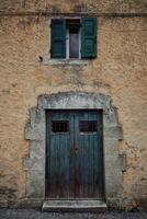 un azul antiguo puerta y ventana en Mediterráneo estilo en Roca pared foto