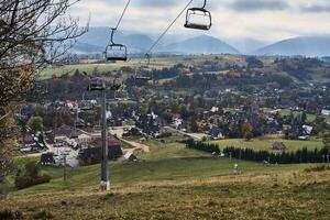 mountain lift, swing set in the autumn mountains photo