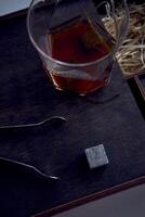 whiskey with tongs, stone cubes, wooden box and wheat on carpet photo