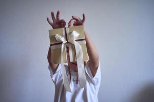 little boy holds a craft gift certificate in his hands photo