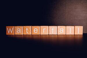 Wooden blocks form the text Waterfall against a black background. photo