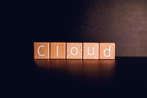 Wooden blocks form the text Cloud against a black background. photo