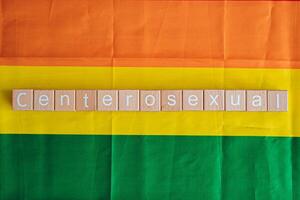 Wooden blocks form the text Centerosexual against a rainbow background. photo